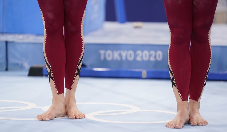 German gymnasts stand with their unitard costumes and wait to perform during the women&#x27;s artistic gymnastic qualifications at the 2020 Summer Olympics, Sunday, July 25, 2021, in Tokyo. (AP Photo/Ashley Landis)