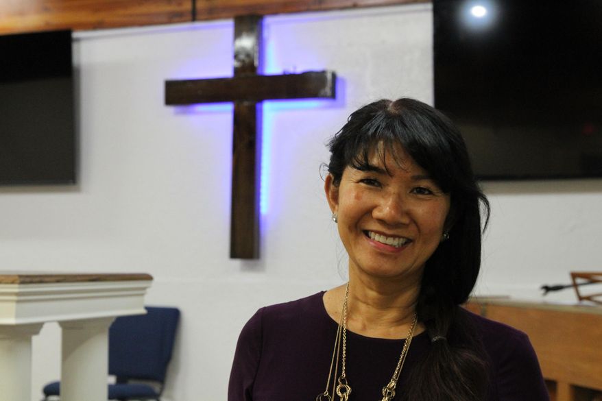 In this May 24, 2021, photo, Linda Dunegan poses for a photo in the sanctuary of the Open Door Baptist Church in Anchorage, Alaska. Dunegan purchased a former strip club and leased the main floor to the church. (AP Photo/Mark Thiessen)