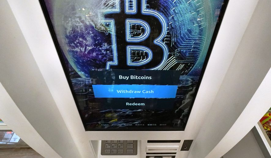 FILE - In this Feb. 9, 2021 file photo, the Bitcoin logo appears on the display screen of a crypto currency ATM at the Smoker's Choice store in Salem, N.H. Bitcoin’s price surged again Monday, July 26, 2021, after speculation that Amazon may be entering the cryptocurrency sector after it posted a job seeking a “digital currency and blockchain product lead.” (AP Photo/Charles Krupa, File)