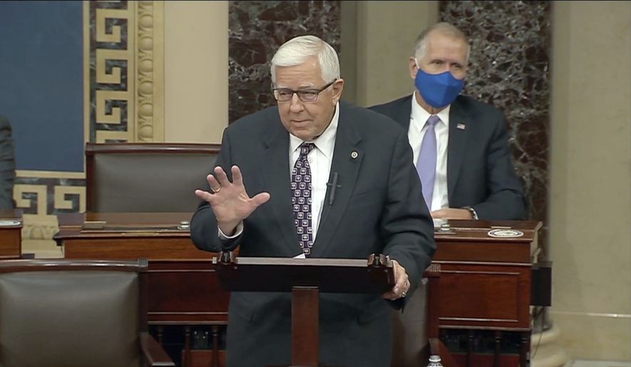 In this Dec. 2, 2020, file photo taken from U.S. Senate video, Wyoming&#39;s low-key senior U.S. Sen. Mike Enzi says goodbye to colleagues, in Washington. Enzi, who was hospitalized Monday, July 26, 2021, with a broken neck and ribs three days after a bicycle accident outside his hometown, has died at age 77. (U.S. Senate via AP, file)