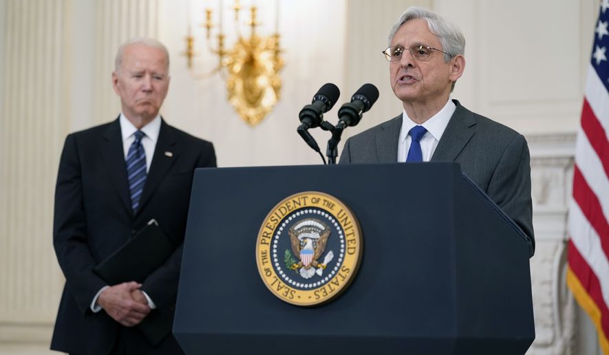 In this June 23, 2021, photo, President Joe Biden listens as Attorney General Merrick Garland speaks during an event in the State Dining room of the White House in Washington to discuss gun crime prevention strategy. (AP Photo/Susan Walsh) **FILE**