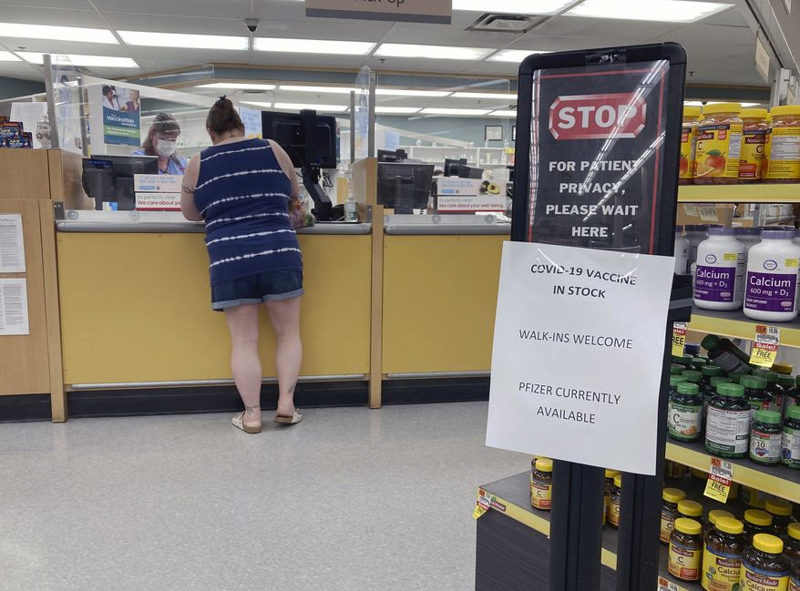 A sign at a pharmacy in a grocery store in Cape May Court House, New Jersey, on Sunday, July 18, 2021, informs customers the Pfizer COVID-19 vaccine is in stock and walk-in coronavirus vaccinations are available. (AP Photo/Ted Shaffrey)