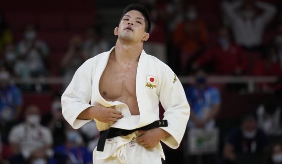 Shohei Ono of Japan reacts after winning the men&#39;s -73kg judo final match against Lasha Shavdatuashvili of Georgia, at the 2020 Summer Olympics in Tokyo, Japan, Monday, July 26, 2021. (AP Photo/Vincent Thian)
