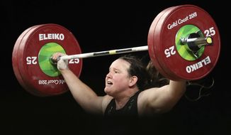 FILE - In this April 9, 2018, file photo, New Zealand&#39;s Laurel Hubbard lifts in the snatch of the women&#39;s 90kg weightlifting final at the 2018 Commonwealth Games on the Gold Coast, Australia. Hubbard, a transgender woman, is competing in weightlifting for New Zealand (AP Photo/Mark Schiefelbein, File)