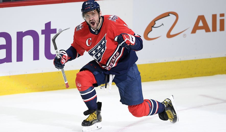 FILE - Washington Capitals left wing Alex Ovechkin celebrates scoring his 718 career goal during the second period of the team&#x27;s NHL hockey game against the New York Islanders in Washington, in this Tuesday, March 16, 2021, file photo. Ovechkin re-signed with the Washington Capitals on the eve of free agency, Tuesday, July 27, 2021, inking a four-year deal worth $40 million.(AP Photo/Nick Wass, File)
