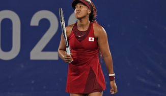 Naomi Osaka, of Japan, reacts after losing a point to Marketa Vondrousova, of the Czech Republic, during the third round of the tennis competition at the 2020 Summer Olympics, Tuesday, July 27, 2021, in Tokyo, Japan. (AP Photo/Seth Wenig)