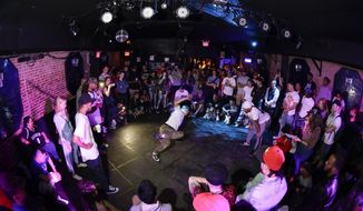 People watch breakers during a competition hosted by Supreme Beingz at the Mercury Lounge Friday, June 7, 2019, in New York.  Many in the breaking community are eager for the art form to expand its audience after the International Olympic Committee announced that it would become an official sport at the Paris 2024 games. But that optimism is hardly unanimous. (AP Photo/Frank Franklin II)