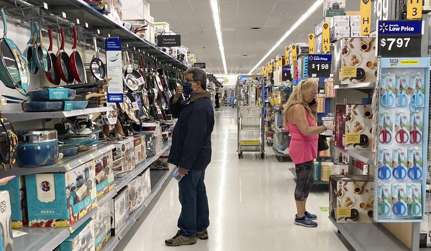 Consumers shop as they wear a mask at a Walmart store in Vernon Hills, Ill., on Sunday, May 23, 2021. (AP Photo/Nam Y. Huh) **FILE**