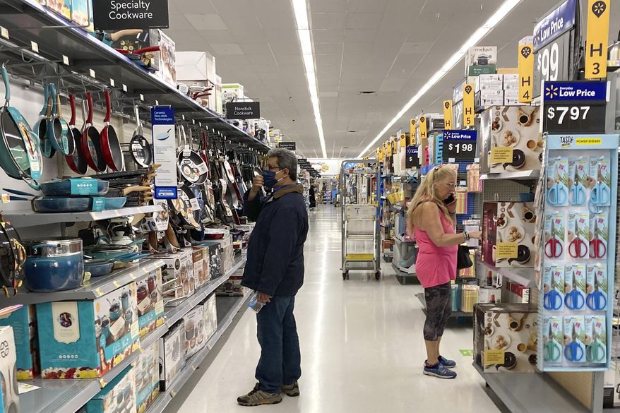 Consumers shop as they wear a mask at a Walmart store in Vernon Hills, Ill., on Sunday, May 23, 2021. (AP Photo/Nam Y. Huh) **FILE**