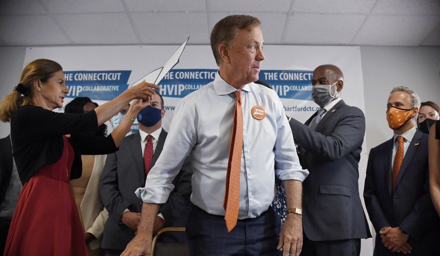 Connecticut Gov. Ned Lamont stands up after signing a ceremonial bill on gun safety at Hartford Communities That Care, Tuesday, July 27, 2021 in Hartford, Conn. (AP Photo/Jessica Hill) ** FILE **