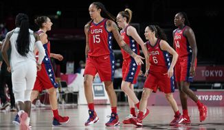 United States of America players celebrate after a three point basket during women&#39;s basketball preliminary round game against Nigeria at the 2020 Summer Olympics, Tuesday, July 27, 2021, in Saitama, Japan. (AP Photo/Charlie Neibergall)