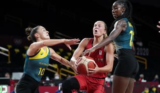 Belgium&#39;s Julie Allemand, center, drives to the basket between Australia&#39;s Katie Ebzery (10) and Ezi Magbegor, right, during a women&#39;s basketball preliminary round game at the 2020 Summer Olympics, Tuesday, July 27, 2021, in Saitama, Japan. (AP Photo/Charlie Neibergall)