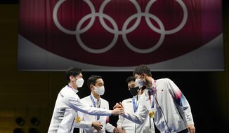 South Korea gold medalists celebrate on the podium of the men&#39;s Sabre team medal at the 2020 Summer Olympics, Wednesday, July 28, 2021, in Chiba, Japan. (AP Photo/Andrew Medichini)