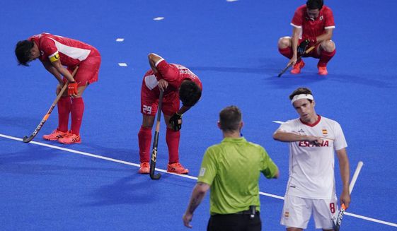 Japan players react after losing to Spain in a men&#39;s field hockey match at the 2020 Summer Olympics, Wednesday, July 28, 2021, in Tokyo, Japan. (AP Photo/John Locher)