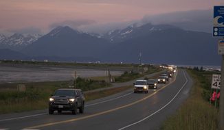 A line of cars evacuates the Homer Spit in Homer, Alaska on July 28, 2021, after a tsunami warning was issued following a magnitude 8.2 earthquake. The tsunami warning for much of Alaska&#39;s southern coast was canceled when the biggest wave, of just over a half foot, was recorded in Old Harbor. Alaska. (Sarah Knapp/Homer News via AP)