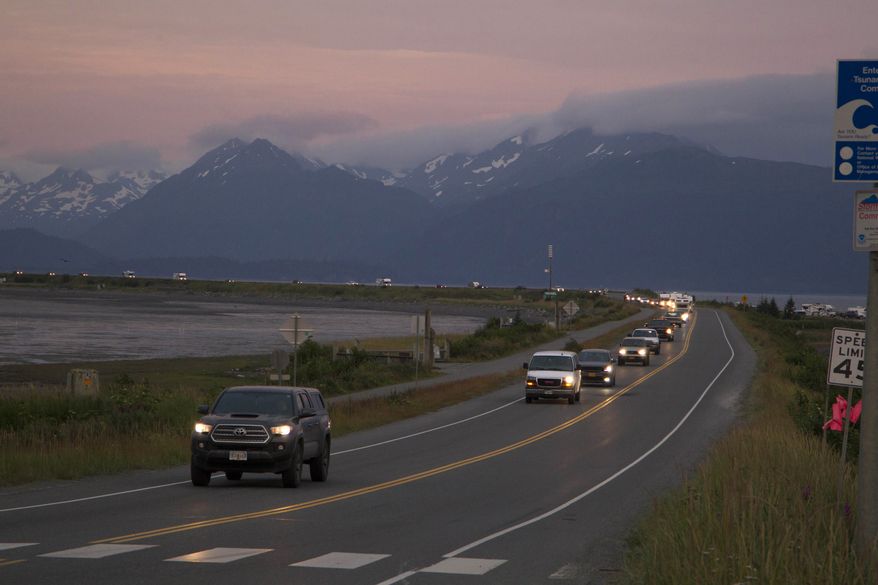 A line of cars evacuates the Homer Spit in Homer, Alaska on July 28, 2021, after a tsunami warning was issued following a magnitude 8.2 earthquake. The tsunami warning for much of Alaska&#x27;s southern coast was canceled when the biggest wave, of just over a half foot, was recorded in Old Harbor. Alaska. (Sarah Knapp/Homer News via AP)