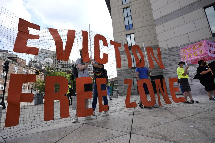 In this June 9, 2021, photo, people hold a sign during a rally in Boston protesting housing eviction. The Biden administration announced Thursday, July 29 it will allow a nationwide ban on evictions to expire Saturday, arguing that its hands are tied after the Supreme Court signaled it would only be extended until the end of the month. The White House said President Joe Biden would have liked to extend the federal eviction moratorium due to spread of the highly contagious delta variant. Instead, Biden called on "Congress to extend the eviction moratorium to protect such vulnerable renters and their families without delay." (AP Photo/Elise Amendola)