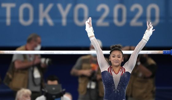 Sunisa Lee, of the United States, finishes on the uneven bars during the artistic gymnastics women&#39;s all-around final at the 2020 Summer Olympics, Thursday, July 29, 2021, in Tokyo. (AP Photo/Ashley Landis)