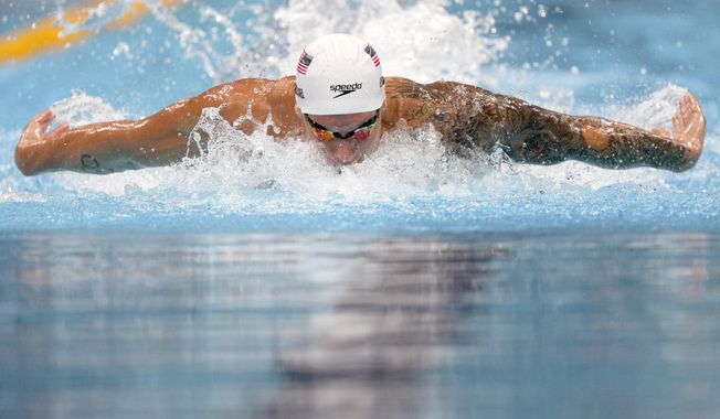 Caeleb Dressel of the United States swims in a heat of the men&#x27;s 100-meter butterfly at the 2020 Summer Olympics, Thursday, July 29, 2021, in Tokyo, Japan. (AP Photo/Matthias Schrader)