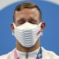 Caeleb Dressel of the United States closes his eyes on the podium after receiving his gold medal for the men&#x27;s 100-meter freestyle at the 2020 Summer Olympics, Thursday, July 29, 2021, in Tokyo, Japan. (AP Photo/Matthias Schrader)