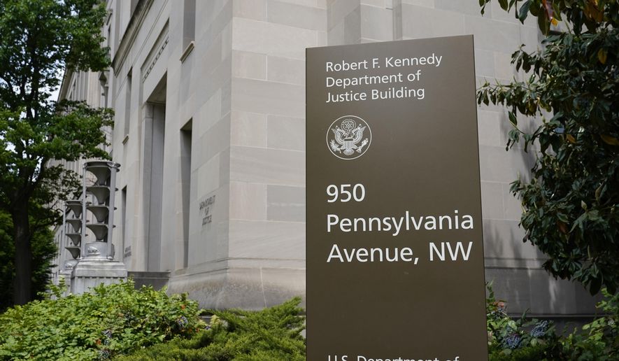This May 4, 2021, file photo shows a sign outside the Robert F. Kennedy Department of Justice building in Washington. Federal prosecutors in Detroit have seized about $12 million in cash that they allege was part of a money laundering scheme operating between the U.S. and the United Arab Emirates.  (AP Photo/Patrick Semansky, File) **FILE**