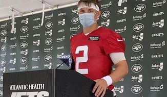 New York Jets rookie quarterback Zach Wilson speaks to reporters after his first practice at the NFL football team&#x27;s training camp in Florham Park, N.J., Friday, July 30, 2021. (AP Photo/Dennis Waszak Jr.)