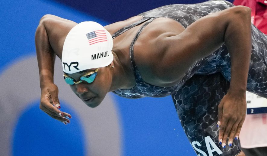 Simone Manuel, of United States, swims in a women&#x27;s 50-meter freestyle heat at the 2020 Summer Olympics, Friday, July 30, 2021, in Tokyo, Japan. (AP Photo/Gregory Bull)