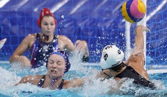 United States&#39; Margaret Steffens (6) gets her shot away as she is defended by Evgeniya Ivanova, lower left, of the Russian Olympic Committee, during a preliminary round women&#39;s water polo match at the 2020 Summer Olympics, Friday, July 30, 2021, in Tokyo, Japan. (AP Photo/Mark Humphrey)
