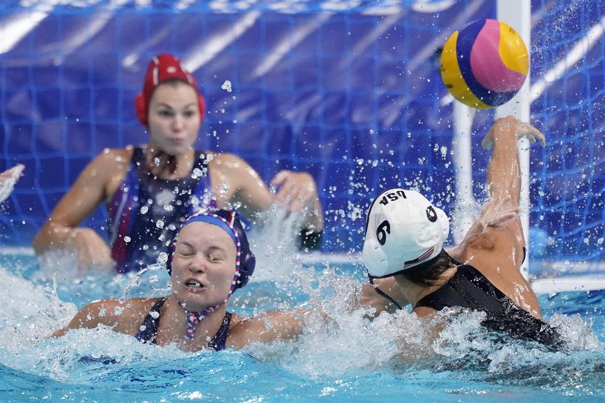United States&#x27; Margaret Steffens (6) gets her shot away as she is defended by Evgeniya Ivanova, lower left, of the Russian Olympic Committee, during a preliminary round women&#x27;s water polo match at the 2020 Summer Olympics, Friday, July 30, 2021, in Tokyo, Japan. (AP Photo/Mark Humphrey)
