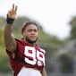 Chase Young (99) waves to the crowd at the Washington Football Team&#39;s NFL training camp Saturday, July 31, 2021, in Richmond, Va. (AP Photo/Dean Hoffmeyer)