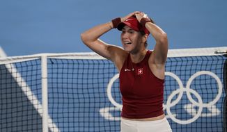 Belinda Bencic, of Switzerland, reacts after defeating Marketa Vondrousova, of the Czech Republic, in the women&#39;s gold medal match of the tennis competition at the 2020 Summer Olympics, Saturday, July 31, 2021, in Tokyo, Japan. (AP Photo/Seth Wenig)