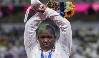 Raven Saunders, of the United States, poses with her silver medal on women&#39;s shot put at the 2020 Summer Olympics, Sunday, Aug. 1, 2021, in Tokyo, Japan. During the photo-op at her medals ceremony Sunday night, Saunders stepped off the podium, lifted her arms above her head and formed an X with her wrists. (AP Photo/Francisco Seco)