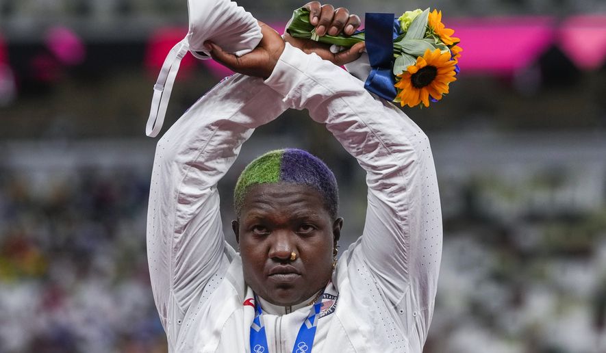 Raven Saunders, of the United States, poses with her silver medal on women&#x27;s shot put at the 2020 Summer Olympics, Sunday, Aug. 1, 2021, in Tokyo, Japan. During the photo-op at her medals ceremony Sunday night, Saunders stepped off the podium, lifted her arms above her head and formed an X with her wrists. (AP Photo/Francisco Seco)