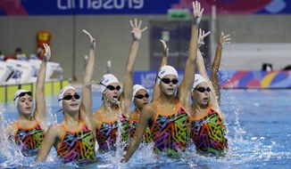 FILE - In this July 25, 2019, file photo, the synchronized swimming team of Cuba performs their routine during a training session at the Pan Am Games in Lima, Peru. Forget boxing or rugby. The most hardcore sport at the Tokyo Games may just be artistic swimming. The sport once known as synchronized swimming has rapidly evolved into one of the most physically grueling specialties at the Olympics. (AP Photo/Fernando Vergara, File)