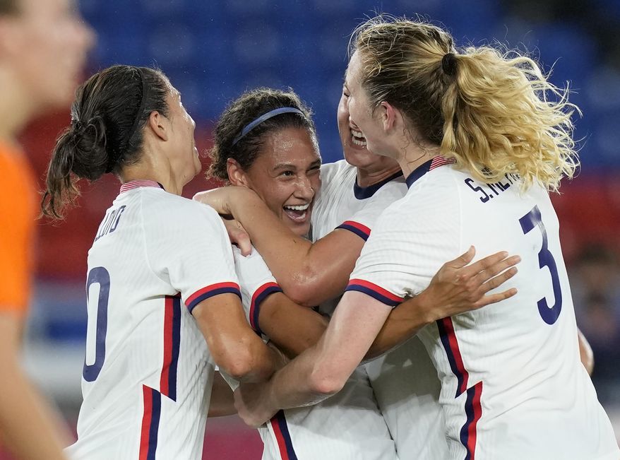 United States' Lynn Williams, center, celebrates with teammates after scoring a goal against Netherlands during a women's quarterfinal soccer match at the 2020 Summer Olympics, Friday, July 30, 2021, in Yokohama, Japan. (AP Photo/Silvia Izquierdo)
