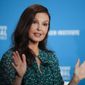 FILE - Actress Ashley Judd speaks at the Milken Institute Global Conference in Beverly Hills, Calif., on April 30, 2018. Judd is walking again, nearly six months after shattering her leg deep in a Congolese rainforest. She tripped and fell and broke her tibia in multiple places, nearly losing her leg altogether. The actress posted a video on Instagram on Sunday where she is seen walking up a hill in a national park in the Swiss alps. She says her leg and foot “worked beautifully.” (AP Photo/Jae C. Hong, File)