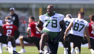 New York Jets offensive lineman Morgan Moses (78) stretches during practice at the team&#x27;s NFL football training facility, Saturday, July. 31, 2021, in Florham Park, N.J. (AP Photo/Rich Schultz) **FILE**