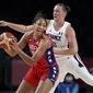 United States&#39; A&#39;Ja Wilson (9), left, passes ahead of France&#39;s Alexia Chartereau (6) during women&#39;s basketball preliminary round game at the 2020 Summer Olympics, Monday, Aug. 2, 2021, in Saitama, Japan. (AP Photo/Charlie Neibergall)