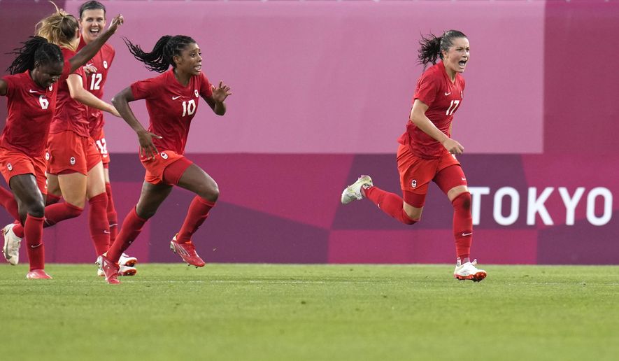 Canada&#x27;s Jessie Fleming, right, celebrates scoring the opening goal from the penalty spot during a women&#x27;s semifinal soccer match against United States at the 2020 Summer Olympics, Monday, Aug. 2, 2021, in Kashima, Japan. (AP Photo/Fernando Vergara)