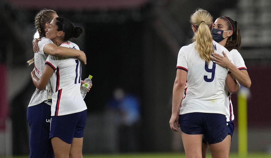 United States players embrace after being defeated 1-0 by Canada during a women&#39;s semifinal soccer match at the 2020 Summer Olympics, Monday, Aug. 2, 2021, in Kashima, Japan. (AP Photo/Andre Penner)