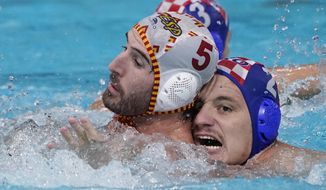 Spain&#39;s Miguel de Toro Dominguez (5) and Croatia&#39;s Marko Macan (2) battle for position during a preliminary round men&#39;s water polo match at the 2020 Summer Olympics, Monday, Aug. 2, 2021, in Tokyo, Japan. (AP Photo/Mark Humphrey)