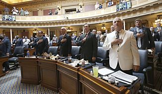 House of Delegates members recite the Pledge of Allegiance to begin the session inside the Virginia State Capitol in Richmond, Va. Monday, Aug. 2, 2021, the first day of the General Assembly Special Session. (Bob Brown/Richmond Times-Dispatch via AP)