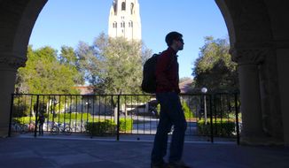 In this Wednesday, Feb. 15, 2012, photo, a student walks in front of Hoover Tower on the Stanford University campus in Palo Alto, Calif. (AP Photo/Paul Sakuma) **FILE**