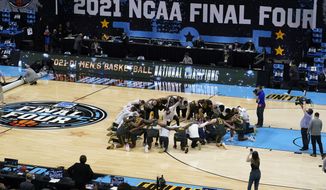 Baylor players huddle on the court at the end of the championship game against Gonzaga in the men&#39;s Final Four NCAA college basketball tournament in Indianapolis, in this Monday, April 5, 2021, file photo. A law firm hired to investigate gender equity concerns at NCAA championship events released a blistering report Tuesday, Aug. 3, 2021, that recommended holding the men&#39;s and women&#39;s Final Fours at the same site and offering financial incentives to schools to improve their women&#39;s basketball programs.  (AP Photo/Darron Cummings, File) **FILE**
