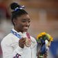 U.S. gymnast Simone Biles poses with her bronze medal for the artistic gymnastics women&#39;s balance beam apparatus at the 2020 Summer Olympics, Tuesday, Aug. 3, 2021, in Tokyo, Japan. (AP Photo/Natacha Pisarenko) ** FILE **