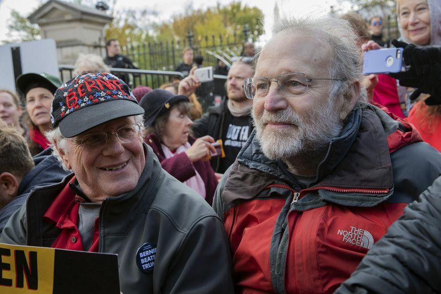 FILE - In this Nov. 8, 2019 file photo, Ben Cohen, left, and Jerry Greenfield, co-founders of Ben &amp;amp; Jerry&#39;s ice cream, attend a protest in Washington. The Vermont-based Ben &amp;amp; Jerry&#39;s has always been known for promoting social causes as much as its flavors of ice cream, but few have attracted as much attention as its decision to stop selling its ice cream in the Israeli-occupied West Bank and contested east Jerusalem. (AP Photo/Patrick Semansky, File)