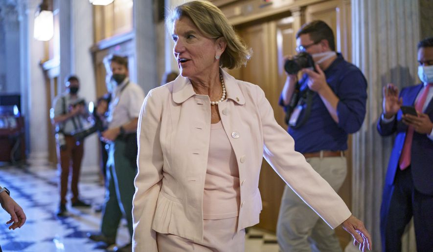 In this file photo, Sen. Shelley Moore Capito, R-W.Va., one of the key Senate Republicans shepherding a $1 trillion infrastructure bill with Democrats, arrives at the chamber as the Senate works to advance the $1 trillion bipartisan infrastructure bill, at the Capitol in Washington, Monday, Aug. 2, 2021. Mrs. Capito is among a number of congressional Republicans accusing Transportation Secretary Pete Buttigieg of crafting new byzantine rules and regulations governing how money from President Biden’s $1.2 trillion bipartisan infrastructure package can be spent. (AP Photo/J. Scott Applewhite)  **FILE**