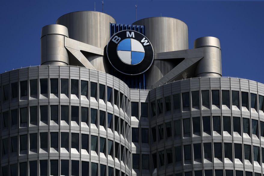 In this Friday, May 14, 2021, file photo, the logo of German car manufacturer BMW is fixed at the headquarters in Munich, Germany. (AP Photo/Matthias Schrader, File)