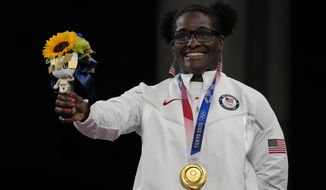 Gold medalist, United States Tamyra Marianna Stock Mensah celebrates on the podium during the medal ceremony for the women&#39;s 68kg Freestyle wrestling at the 2020 Summer Olympics, Tuesday, Aug. 3, 2021, in Chiba, Japan. (AP Photo/Aaron Favila)