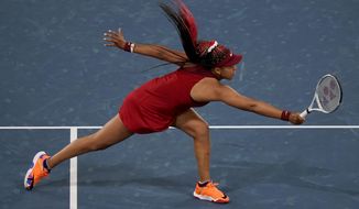 In this July 27, 2021, file photo, Naomi Osaka, of Japan, reaches for a shot by Marketa Vondrousova, of the Czech Republic, during the third round of the tennis competition at the 2020 Summer Olympics, in Tokyo, Japan. (AP Photo/Seth Wenig, File)